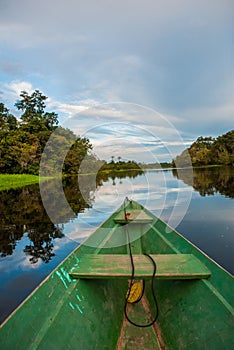 Traditional wooden boat floats on the Amazon river in the jungle. Amazon River Manaus, Amazonas, Brazil