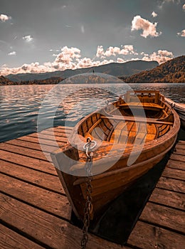 Traditional wooden boat Pletna on the backgorund of Church on the Island on Lake Bled, Slovenia. Europe