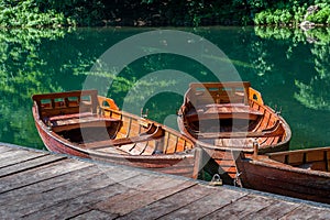 Traditional wooden boats at forest lake pier