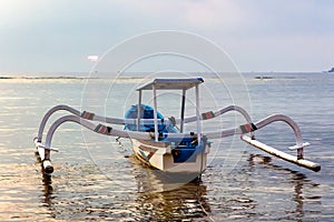 Traditional wooden boats on a tropical beach at sunset