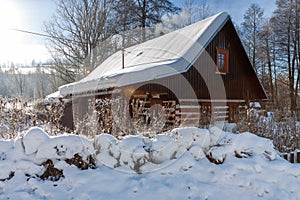 Traditional wooden cottage in winter