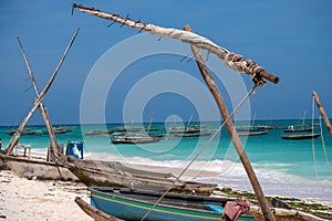 Traditional wooden dhow boats on the White Sand Beach with amazing turquoise water in the Indian ocean at Nungwi village