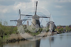 A traditional wooden Dutch windmills in the Netherlands at the river - Kinderdijk