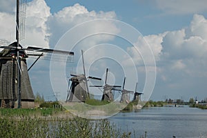 A traditional wooden Dutch windmills in the Netherlands at the river - Kinderdijk