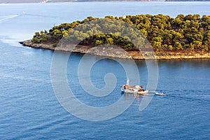 A traditional wooden fishing boat floating on the colorful waters, Ermioni, Greece