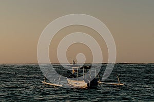 traditional wooden fishing boat in the middle of sea