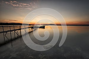 A traditional wooden fishing boat in the sea. Boat in the end of