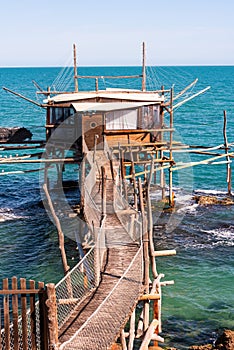 Traditional wooden fishing house with a net near sea coast