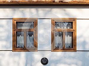 Traditional wooden framed windows curtains in a village in Hungary