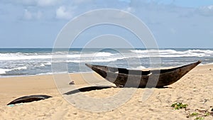 Traditional wooden hand made African / Malagasy fishing boat - piroga on the sandy beach of Indian ocean in Madagascar