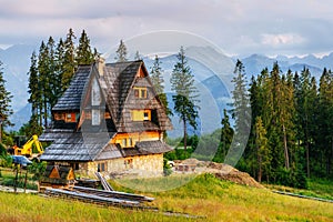 Traditional wooden house in the mountains on a green field Mountains, Poland