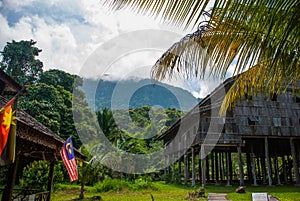 Traditional wooden house near mountain in the background. Kuching to Sarawak Culture village. Borneo, Malaysia