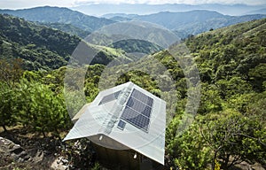 Traditional wooden house with solar panels in the mountains