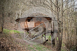 Traditional wooden hut in the trees in the forest