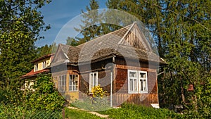 Traditional wooden mountain house on green field in Pieniny Mountains.