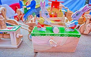 The traditional wooden moving toy  in form of rabbits sawing firewood on carpenter`s stall on Independence Day Fair in Dnipro,