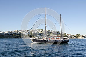 Traditional wooden sail cruise boat floating to Piraeus port, Greece