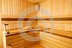 Traditional wooden sauna. Classic interior. Empty seats, bucket lies