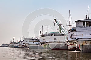 Traditional wooden ships Pinisi line up in Jakarta old port photo