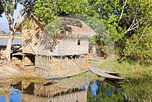 Traditional wooden stilt house and canoe