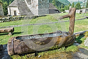 Traditional wooden water fountain in the mountains