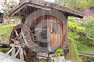 Traditional wooden water wheel spinning at Tsumago - juku in Tsumago