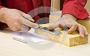 Traditional woodworker using chisel photo