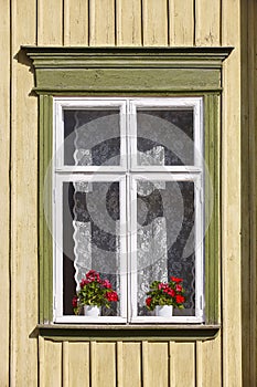 Traditional yellow wooden house facade in Rauma town. Finland he