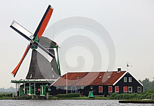 Traditional zaanse schans windmill in The Netherlands. Unique beautiful and wild European city.