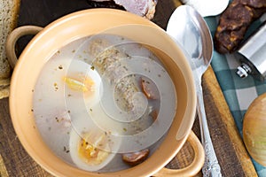 Traditional Zurek with sausage and egg, white borscht, polish Ea