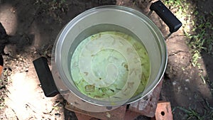 Traditionally cooked tempe lodeh on fire outdoor