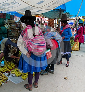 Traditionaly dressed latin american women in the village area