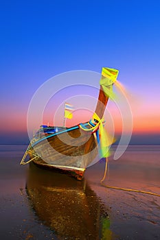 Traditionnal long tail boat at sunset