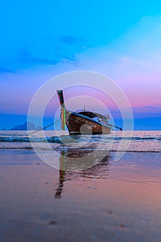 Traditionnal long tail boat at sunset