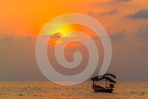 Traditionnal long tail boat at sunset