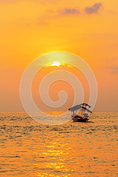 Traditionnal long tail boat at sunset