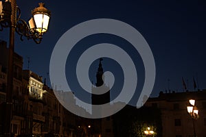Lights from the palaces and the bell tower of the city center photo