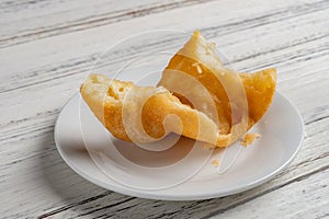 Traditonal Chinese friedcake with bites on white wood background