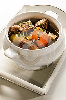 Traditonal irish stew in a bowl, served on a tray
