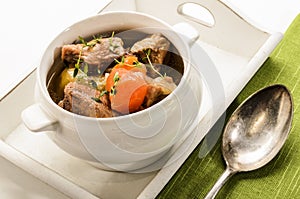 Traditonal irish stew in a bowl, served on a tray