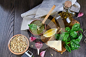 Tradizione Italiana Homemade Pesto recipe ingredients on dark table. photo