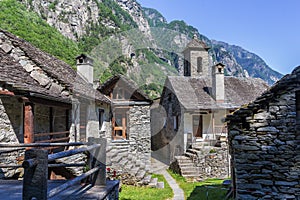 The tradtional stone houses with church tower in the beautiful village of Foroglio, photo