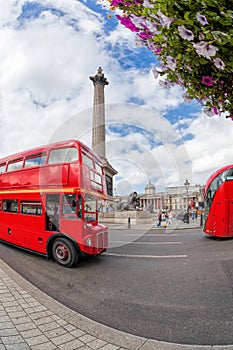 Trafalgal square with red buses in London, England