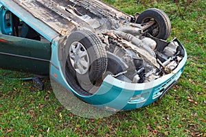 Traffic accident, car after rollover lie on the roof photo