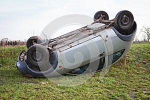 Traffic accident, car after rollover lie on the roof photo