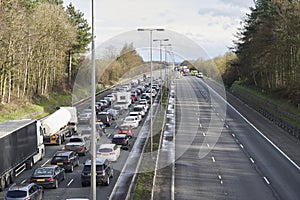 Emergency services closing motorway to attend accident causing a traffic jam photo