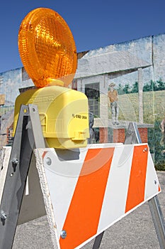 Traffic barricade set against a painted wall photo