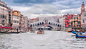 Traffic with boats on the Grand Canal in front of the Rialto Bridge in Venice, Veneto, Italy