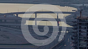 Traffic on a busy intersection in Dubai downtown night to day timelapse. Top view from above