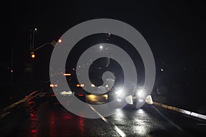 traffic on car wet road at night in bad weather, red light. Blackout in Ukraine,